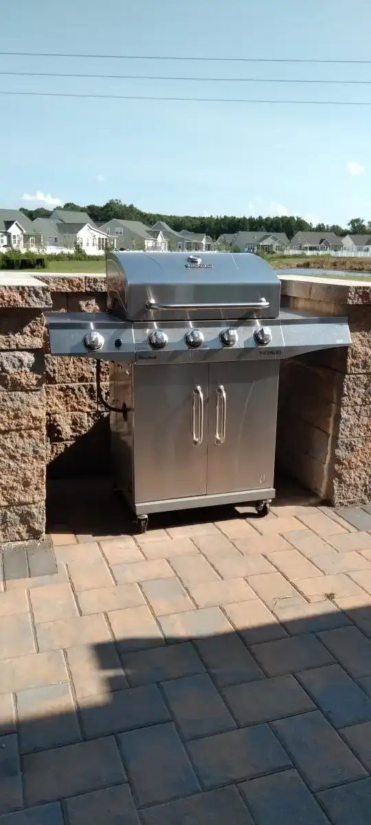 Outdoor kitchen with grill island and stone base