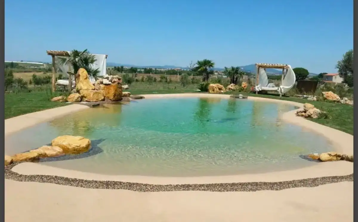 Completed pool installation with stone surround in Delaware